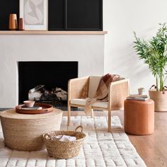 a living room filled with furniture and a fire place in front of a white fireplace