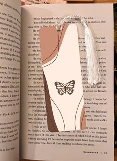 an open book with a butterfly on it