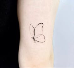 a small black butterfly tattoo on the right side of the leg, it's wings are