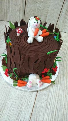 a chocolate cake with carrots and an animal on top