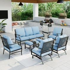 an outdoor patio with blue cushions and chairs