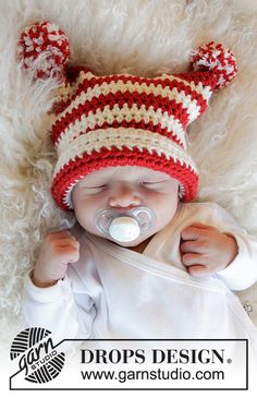 a newborn baby wearing a red and white hat