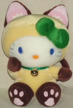 a hello kitty stuffed animal with a green bow on it's head and paws