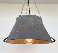 a metal light fixture hanging from a ceiling