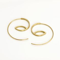 These are minimalist delicate gold hoop earrings, handmade of yellow 14k solid gold.I made these gold hoops of a rectangle gold wire, 2 mm wide x 1 mm thick. They have a delicate matte finish.Width of the delicate long ear wire (the wire that goes into the ear lobe) is 0.8 mm = about 0.3 inch. These modern hoops are unique, and will add chic to any outfit. They are perfect for everyday’s wear, as well as for a night out. Elegant, minimal and eye catching.Total length of the earrings is 3.1 cm = Modern Gold Wire Wrapped Hoop Earrings, Luxury Brass Hoop Earrings With Ear Wire, Modern Yellow Gold Brass Hoop Earrings, Gold-tone Brass Hoop Earrings With Ear Wire, Modern Hoop Earrings, Hoop Earrings Handmade, Gold-tone Brass Hoop Earrings With Polished Finish, Hoop Earrings Gold, Earrings Minimalist