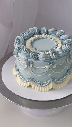 a blue and white cake sitting on top of a table