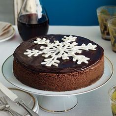 a chocolate cake with white snowflakes on it