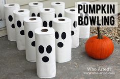 a bunch of toilet paper sitting on the ground next to a pumpkin