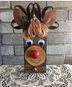 a paper bag with a reindeer head on it and some hair in the shape of a nose