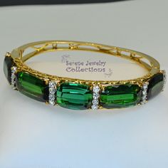 Beautiful one of a kind rare Chrome Green Tourmaline 18k solid yellow gold vintage bracelet. Green tourmaline of this color, size and quality are extremely rare and come together in a stunning elegant design! Complementing the sides of the tourmalines are very sparkly white diamond rounds, totaling 1 carats. Total Weight: 31.26 grams Bracelet length: 7 inches Face Size: 12.15mm Wide, 8.72mm thick Precious Metal: 18k yellow gold Precious stones: -Chrome Green Tourmaline Cut Stones: 40 carats, QTY Elegant Green Gold Bracelet For Formal Occasion, Elegant Oval Green Bangle, Green Bangle For Formal Occasions, Fine Jewelry Style, Elegant Green Oval Bangle, Elegant Gold Tourmaline Bracelets, Luxury Green Faceted Jewelry, Luxury Multicolor Tourmaline Bracelets, Luxury Baguette-cut Tourmaline Jewelry, Luxury Gold-colored Polished Sterling Silver Bracelet