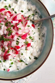 a bowl filled with yogurt and chopped radishes