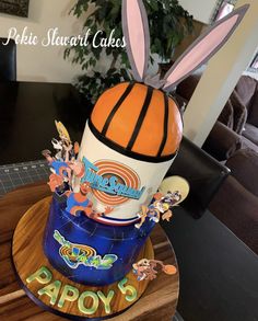 a cake made to look like a basketball and some cartoon characters on top of it