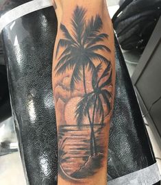 a man with a palm tree tattoo on his arm