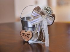 a metal bucket with a wooden heart on it