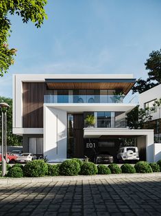 a modern house with two cars parked in the driveway