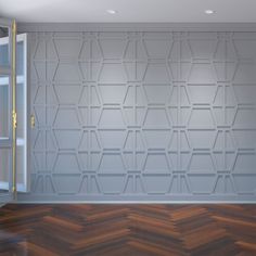 an empty room with wood flooring and white painted walls, along with shelving units