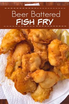 beer battered fish fry on a plate with lemon wedges