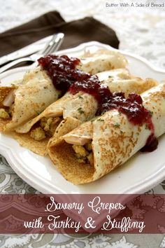 crepes on a white plate topped with sauce