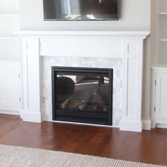 a fireplace with a television mounted above it