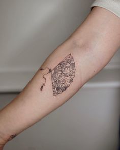 a woman's arm with a tattoo design on the left side of her arm