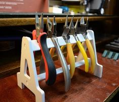 several pairs of scissors are hanging on a rack