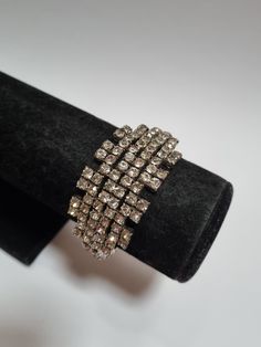 A glorious crystal evening cuff. The design is as fascinating as it is beautiful.  Excellent vintage condition, with all crystals shiny and present. The outer circumference measures approx 17cm, and the width is 3cm.  Clean and ready to wear. -------------------- 🌟 P&P: 👉 Will arrive gift wrapped, in a padded bag. 👉 UK shipping: Royal Mail Tracked 24 👉 International Shipping: Royal Mail International Tracked -------------------- 💎 FOLLOW US:  👉 www.instagram.com/janedreamsofvintage 👉 www.facebook.com/JaneDreamsOfVintage Geometric Crystal, Padded Bag, Crystal Cuff Bracelet, Pad Bag, 50s Vintage, Black Leather Bags, Wedding Bracelet, Link Necklace, New Vintage