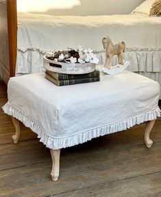 a white ottoman with a cake on top of it