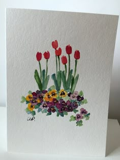 a card with watercolor flowers on it