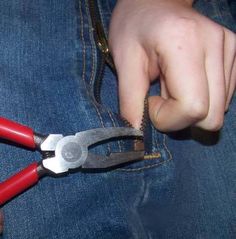 a person is holding some scissors in their pocket and pulling on the handles with both hands