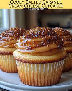 three cupcakes with caramel icing and sprinkles on top