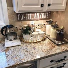 a kitchen counter with cakes and coffee on it, next to a sign that says coffee anyone?