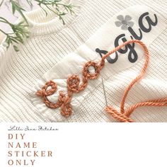 an orange thread is on top of a white sweater with the words, diy name sticker only