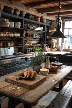 a wooden table topped with plates and bowls next to a stove top oven filled with food