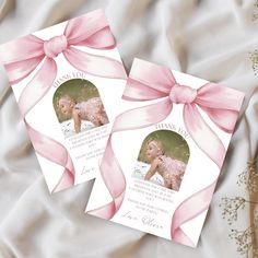 two wedding thank cards with pink ribbon and bow on white satin fabric, one has a photo of the bride