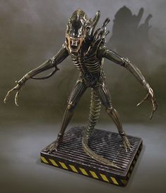 an alien is standing on a platform with his arms outstretched and legs spread out to the side