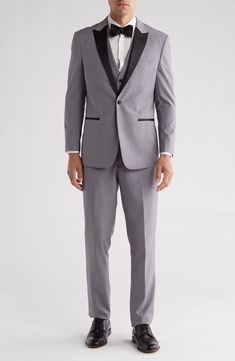 Bring understated elegance to the table in this three-piece tuxedo crafted from rich fabric in a classic single-breasted silhouette. Jacket has shawl collar; chest welt pocket; front welt pockets Vest has front button closure; V-neck Pants have zip fly with button closure; front slant pockets; back button-welt pockets Jacket and vest are lined; trousers are lined to the knee 65% polyester, 35% viscose Dry clean Imported Each suit has a 6” drop, meaning that a size 38R jacket is paired with size Tailored Tuxedo Party Sets, Fitted Tuxedo Sets For Parties, Evening Tuxedo Sets, Elegant Black Tie Slim Fit Three-piece Suit, Classic Fitted Three-piece Suit For Black Tie Event, Fitted Tuxedo Three-piece Suit For Party, Fitted Classic Three-piece Suit For Black Tie Event, Fitted Tuxedo Sets For Formal Occasions, Classic Fitted Three-piece Suit For Party