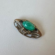 Gorgeous Italian Art Nouveau Aventurine Brooch, dated from the 1920's. Aventurine is considered the luckiest of all crystals. Unidentified marker stamped on the back, shown in photos. In great vintage condition. Due to the vintage nature of this item, it has not been cleaned or polished and you will see minor blemishes and tarnish that you may choose to clean. Approximately 1.25" x 0.25". Art Deco Cabochon Brooches Collectible, Collectible Art Deco Cabochon Brooches, Vintage Green Evening Brooches, All Crystals, Antique Green Clip-on Jewelry, Antique Green Gemstone Brooches, Luxury Collectible Art Nouveau Brooch, Vintage Green Rhinestone Brooch, Luxury Silver Art Nouveau Brooch