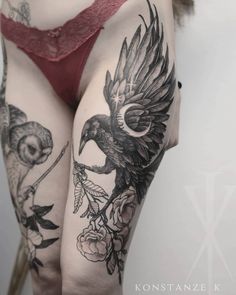 the back of a woman's thigh with tattoos on her legs and an eagle