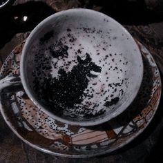 a dirty cup sitting on top of a plate