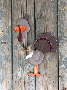 two turkey shaped cookies sitting on top of a wooden table