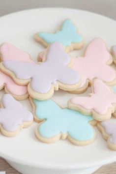 cookies decorated with pastel colors on a white plate