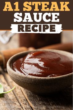 a wooden bowl filled with sauce on top of a table