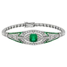 This luminous and luxurious Art Deco style jewel features a center approx. 2.16 carat emerald, framed by approx. 2.16 carat glittering round diamonds and vibrant green French cut emeralds. A slender, streamlined and simply stunning Art Deco design bracelet. Bracelet Information Style: Art Deco Metal: 18K White Gold Width: 16 mm. Length: 55 mm. Weight: 22.15 g. (approx. in total) Center Gemstone Type: Emerald Shape: Octagon Size: 9 x 7 mm. Number: 1 Weight: 2.16 Carat (approx. in total) Accent Ge Art Deco Metal, Emerald Bracelet, Antique Bracelets, Bracelet Box, White Gold Bracelet, Estilo Art Deco, Gorgeous Jewelry, Diamond Bracelets, Emerald Diamond