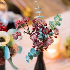 two vases filled with flowers on top of a table