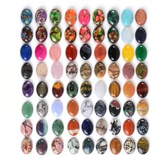 an assortment of different colored stones on a white background