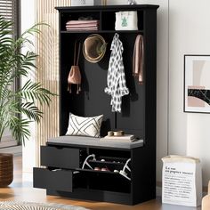 an entryway with a bench, coat rack and shoes on the floor next to a potted plant