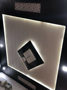 an overhead view of a bathroom with black and white tile on the walls, lighting up the ceiling