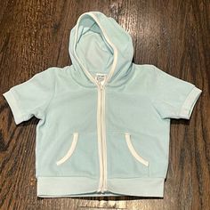 Uniqlo Short Sleeve Hoodie Size 12-18m. Zip Close. New With Tags. Unisex Cotton Hoodie With Adjustable Hood For Playtime, Cotton Hooded Hoodie For Playtime, Cotton Hooded Sweatshirt For Playwear, Hooded Cotton Sweatshirt For Playwear, Cute Blue Tops With Drawstring Hood, Cotton Hoodie Sweatshirt For Playtime, Cotton Hooded Hoodie For Playwear, Cute Blue Hoodie Top, Playful Hooded Tops For Loungewear