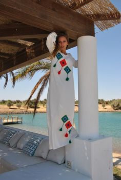 A stunning embroidered Kaftan dress that is elegant, colorful, and unique! The dress is made of Egyptian cotton that has a soft feel to it so you will surely feel comfortable and royal in it.  -----------Medium------------ Bust : 39-40 Hip : 45-46  -----------Large---------------- Bust : 44-45 Hip : 50-51  -----------X-Large-------------- Bust : 47-48 Hip : 53-54  -----------XX-Large-------------- Bust : 49-50 Hip : 55-56 Length : 57 inches (145cm) Composition : 70% Egyptian Cotton; 30% Polyeste Traditional Floor-length Tassel Dresses, White Maxi Dress For Eid Vacation, White Maxi Dress With Tassels, Traditional Maxi Dress With Tassels, Traditional Tassel Maxi Dress, Traditional White Dress With Tassels, White Maxi Dress For Beach Eid Festival, White Beach Maxi Dress For Eid, White Maxi Dress For Beach And Eid