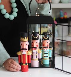 the nutcrackers have been made out of wood and are being held by a woman